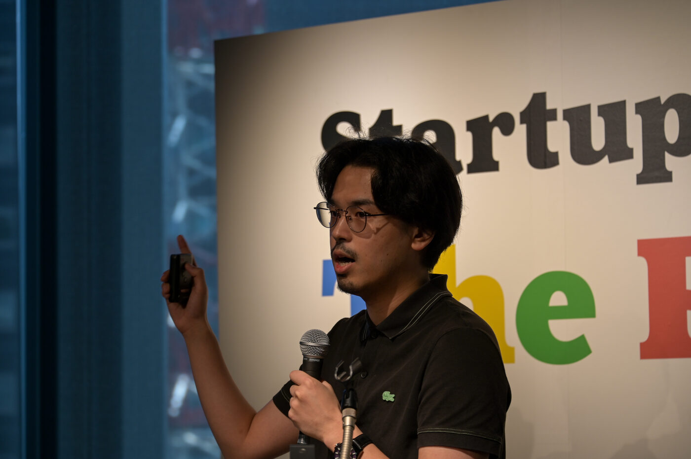 Yoshiki Matsumura, President & CEO, presenting on stage